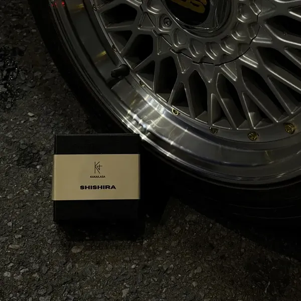 K4KAILASA SHISHIRA box beside a BBS wheel at a car meet